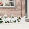 Christmas reindeer decorations in the snow outside a house. Podgląd zdjęcia produktu