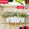 A white planter box with purple flowers attached to a wooden fence. Náhľad obrázku produktu