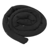 A black, coiled hair accessory is shown against a white background. Náhled obrázku produktu