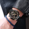 A close-up shot of a man's wrist wearing a black and gold watch and a blue braided bracelet, with a black leather jacket in the background. Náhled obrázku produktu
