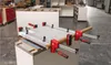 A workshop setting where a piece of material is being clamped. Produktbild-Vorschau