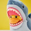 A close-up shot of a plush shark toy with its mouth open, revealing a plush duck toy inside. Podgląd zdjęcia produktu