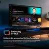 A Samsung TV displaying the Samsung TV Plus interface, placed on a media console. Produktbild-Vorschau