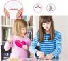 Two young girls are sitting at a table and making jewelry with beads. Produktbild-Vorschau
