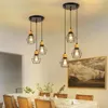 A dining room with a table set for a meal, illuminated by pendant lights. Voir les images du produit