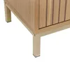 A close-up view of the bottom corner of a wooden cabinet with metal legs. Podgląd zdjęcia produktu
