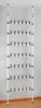 A tall, narrow, freestanding shoe rack with multiple horizontal bars, each holding multiple shoe clips, extending from floor to ceiling. Náhled obrázku produktu