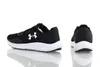 A pair of black and white Under Armour sneakers are shown against a white background. Produktbild-Vorschau