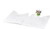 A small fairy figurine stands on an open coloring book. Produktbild-Vorschau