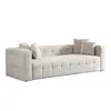 A studio shot of a beige bouclé sofa with throw pillows, presented on a white background. Voir les images du produit