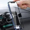 A hand is placing a smartphone into a car phone mount attached to an air vent. Náhled obrázku produktu