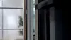 A close-up view of a refrigerator door and a window with a plant visible through it. Produktbild-Vorschau