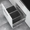 A pull-out kitchen bin system with two dark gray bins inside a white cabinet drawer. Produktbild-Vorschau