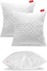 Three white pillows with a quilted, scalloped pattern are displayed against a white background. Two pillows are stacked slightly behind and to the side of each other, while the third is shown from a side angle at the bottom. Produktbild-Vorschau
