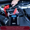 A person is shown connecting a car battery charger to a car battery. Produktbild-Vorschau