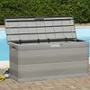 A grey storage box is placed next to a swimming pool, with a green hedge in the background. Produktbild-Vorschau