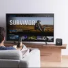 A person is sitting on a couch watching TV, with a media player box on a wooden table next to the TV. Anteprima dell’immagine prodotto