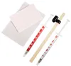 A kit for removing scratches from glass surfaces, including two syringes with repair and finishing compounds, a wooden applicator stick, and a cleaning cloth with a notepad. Produktbild-Vorschau