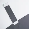 A close-up view of a dark gray curtain with white loops attached. Produktbild-Vorschau