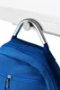 A blue backpack hanging from a silver hook attached to a white shelf. Produktbild-Vorschau