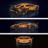 A collage of three images showing a detailed orange toy car model from different angles. Voir les images du produit
