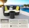 A rattan furniture set with cushions and a table is placed on a patio next to a swimming pool with a scenic ocean view. Náhled obrázku produktu