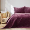 A bedroom scene with a bed and a chair. Produktbild-Vorschau