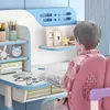 A child sitting at a blue and white desk with pink chair. Produktbild-Vorschau