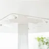 A close-up view of the underside of a white round table, showing the central support column and some of the mounting hardware. Náhľad obrázku produktu