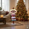 A festive Christmas scene with a decorated tree, gifts, and a lit signpost pointing to the North Pole. Podgląd zdjęcia produktu
