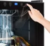 A hand is shown interacting with the control panel of a wine cooler. Produktbild-Vorschau