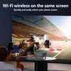 A person is using a smartphone to mirror their screen to a projector, which is displaying a racing car on a large screen. Produktbild-Vorschau