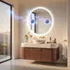 A modern bathroom vanity with a round LED mirror, sink, and accessories, with a scenic view through a large window. Anteprima dell’immagine prodotto