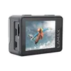 A black action camera with a screen displaying a snowboarder in mid-air. Náhľad obrázku produktu