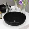 A black ceramic sink with a chrome faucet on a white countertop. Podgląd zdjęcia produktu