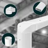 A collage of white plastic ventilation ducting components against a blurred industrial background. Podgląd zdjęcia produktu