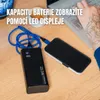A black power bank is charging a smartphone on a wooden desk, with a laptop and a cup in the background. Produktbild-Vorschau