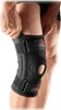 A person is putting on a knee brace. Podgląd zdjęcia produktu