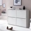 A white shoe cabinet with four drawers is shown in a room with pink walls and a white floor. Two brown high-heeled shoes are placed on a rug in front of the cabinet. Náhled obrázku produktu