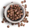 A bowl of brown kibble with some kibble scattered around it on a white background. Produktbild-Vorschau