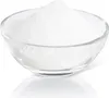 A clear, well-lit studio shot of a glass bowl filled with white powder. Produktbild-Vorschau