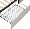 A close-up view of the underside of a bed frame, showing a wire storage basket and wooden slats. Náhled obrázku produktu