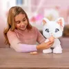 A young girl is playing with a white toy cat. Náhľad obrázku produktu