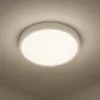 A white, round ceiling light fixture mounted on a light gray ceiling. Náhľad obrázku produktu