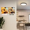 A modern kitchen with a ceiling light and a dining table. Náhľad obrázku produktu
