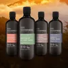 Four bottles of Baylis & Harding Goodness natural shower gel for men are displayed in front of a blurred background of a forest and sunset. Produktbild-Vorschau