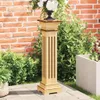 A wooden plant stand with a floral arrangement on top, placed outdoors on a patio next to greenery and a brick wall. Náhľad obrázku produktu