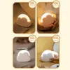 A collage of four images showing a cloud-shaped LED night light in different settings and brightness levels. Produktbild-Vorschau