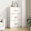A white cabinet with brown handles sits in a room with a couch and curtains. Voir les images du produit