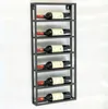 A black metal wine rack mounted on a white wall, holding six bottles of wine. Náhľad obrázku produktu